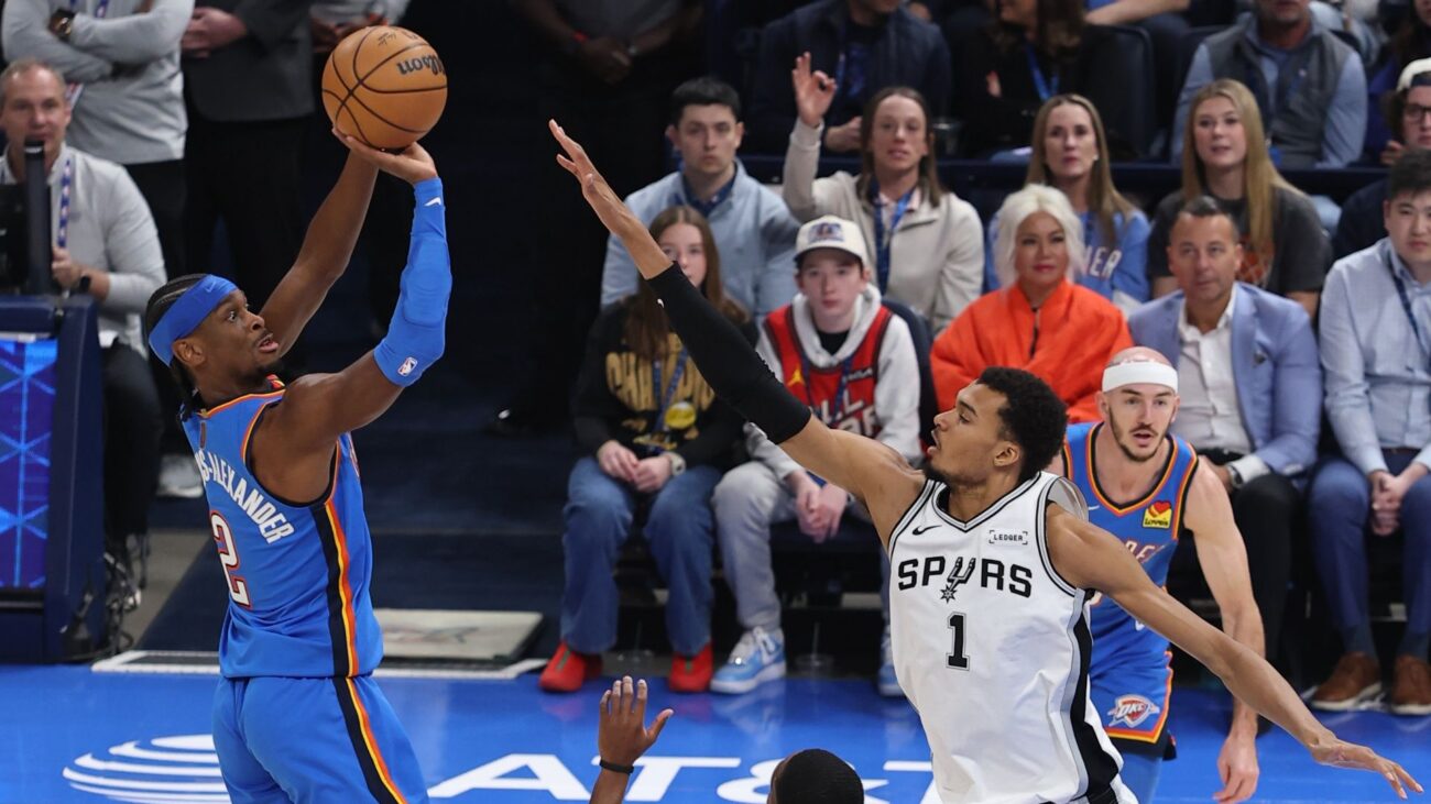 Shai Gilgeous-Alexander of the Oklahoma City Thunder shoots the ball as Victor Wembanyama of the San Antonio Spurs plays defense
